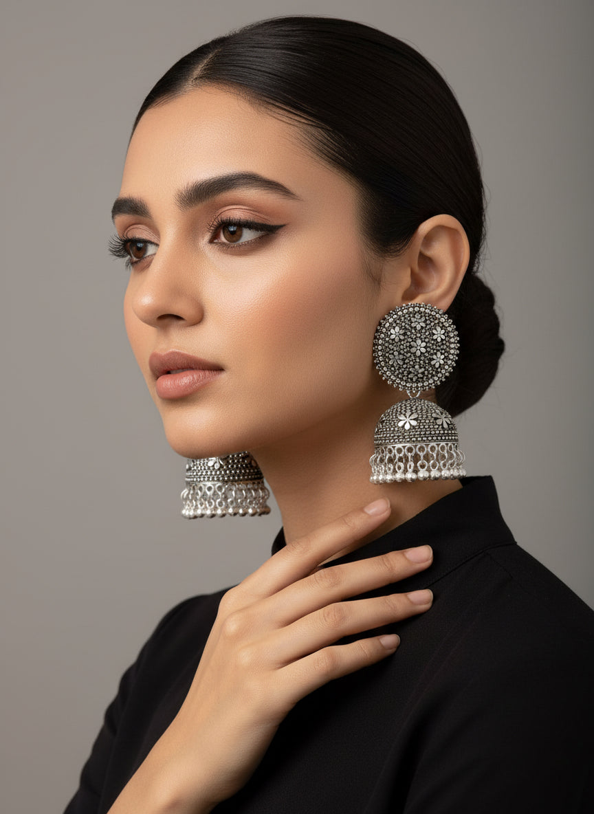 Model wearing silver oxidised teardrop filigree earrings