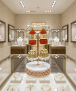 A pair of gold-plated sugar stone drop jhumka earrings with pink stones and white pearl-like accents.