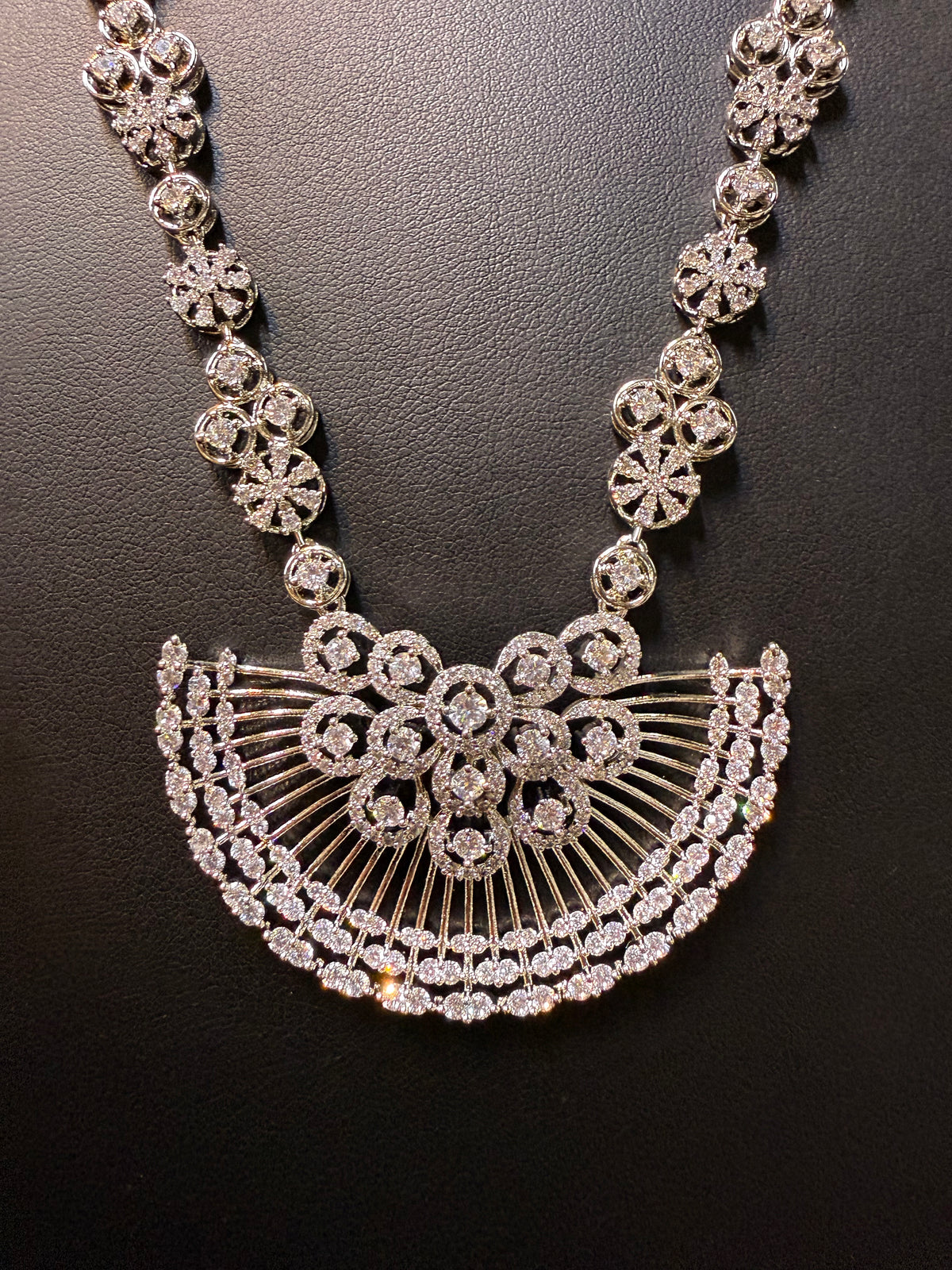 Gold plated floral necklace and earrings set with white accents