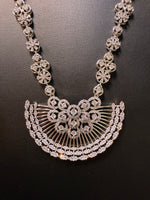 Gold plated floral necklace and earrings set with white accents