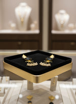 A pair of gold-plated Mona Lisa pendulum earrings featuring green stones and silver pearls.