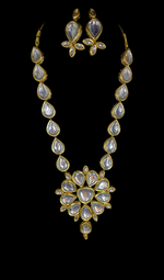 A gold-toned Kundan mala necklace with polki kundan embellishments and matching earrings
