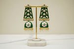 A pair of gold-plated Meenakari long Jhumka earrings with green and white enamel work and pearl accents.