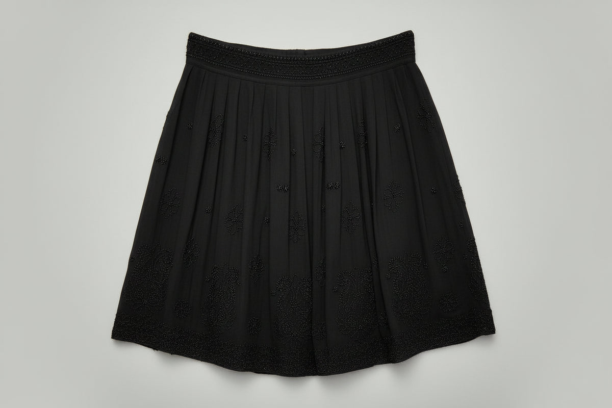 Gray skirt with floral embroidery on a light gray background