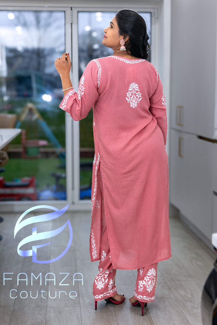 rear view of model wearing Floral chikankari kurti palazzo set in pink with white embroidery