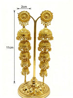Pair of 5-tier cascading gold jhumka dangle earrings on gold display stand, dimensions: length 11cm, width 2cm, ornate rosette top, five graduated filigree domes, premium gold-plated traditional South Asian bridal jewelry, white background.