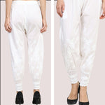 White lace pants worn by a person on a plain background