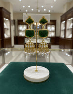 A pair of gold-plated sugar stone drop jhumka earrings with pink stones and white pearl-like accents.