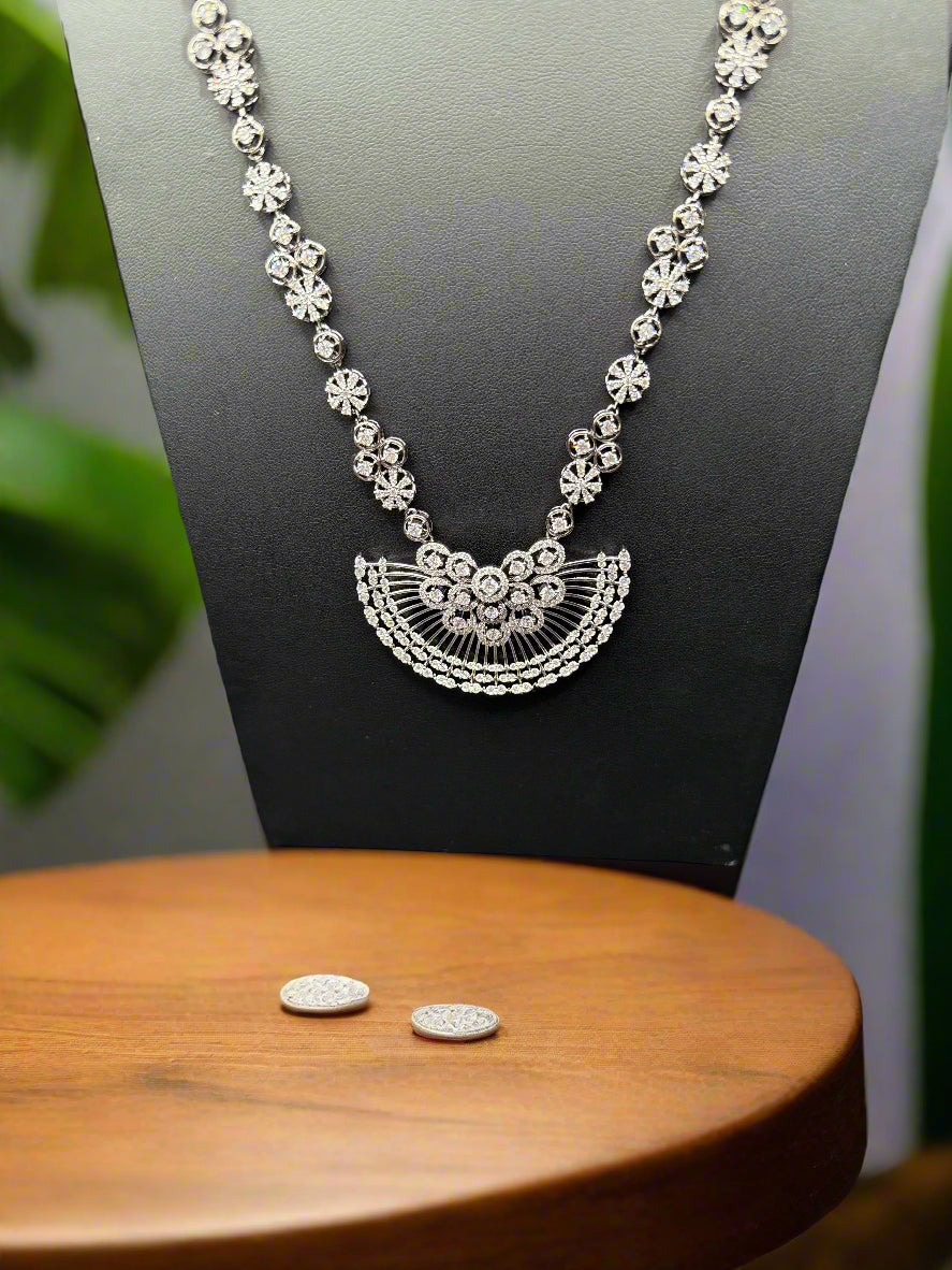 Gold plated floral necklace and earrings set with white accents