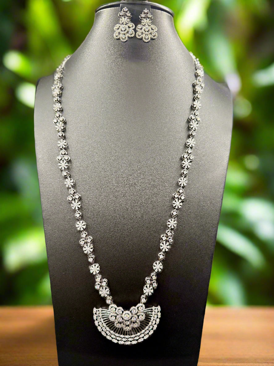 Gold plated floral necklace and earrings set with white accents