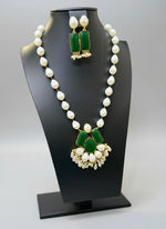 A luxury Bollywood style Mala Set featuring white beads, pearls, and bottle green stones inclusions, displayed on a mannequin bust. Party wear set.