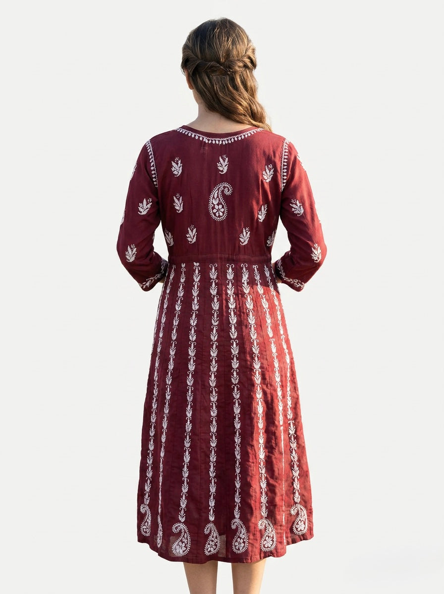 A Model is showing the rear view of this Maroon chikankari hand embroidered Aanarkali long dress.