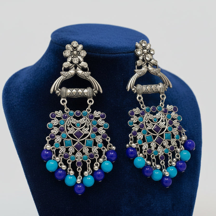 A Pair of oxidised earrings with blue and navy blue beads