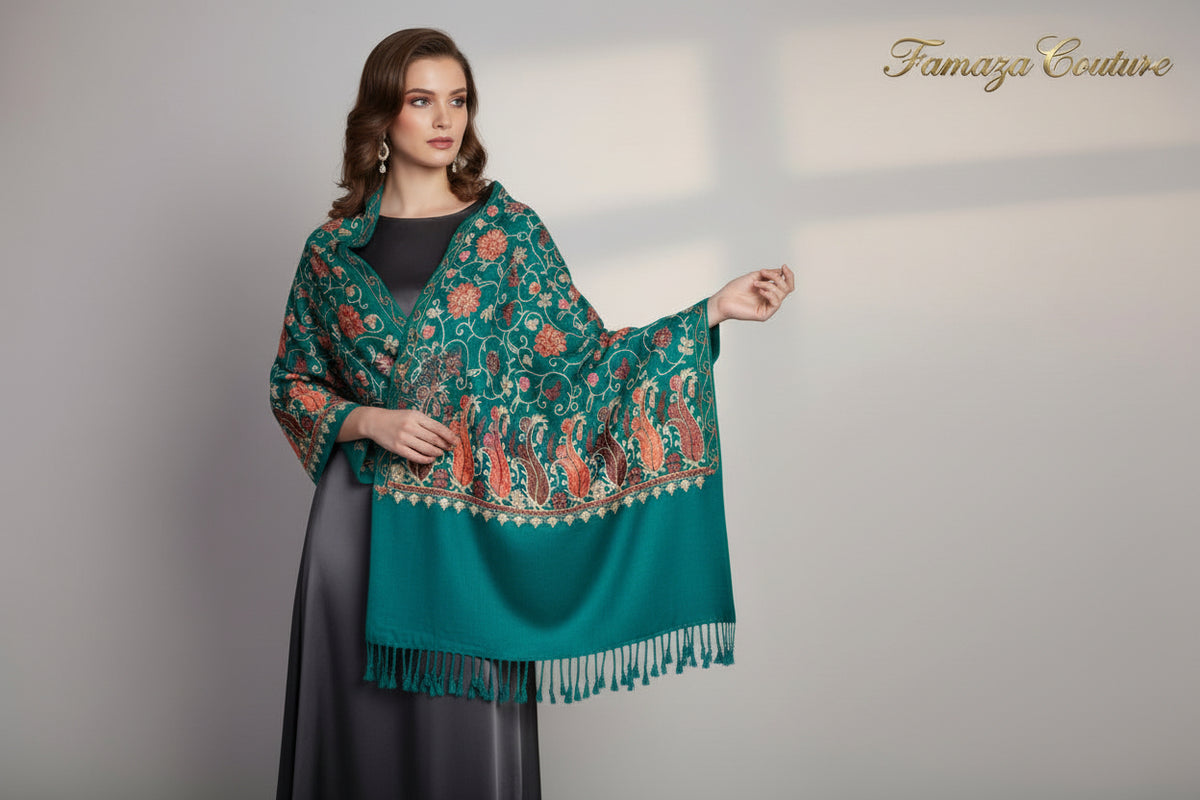 A Teal blue pashmina scarf with Kashmiri Aari embroidery in a floral pattern, featuring tassels on the ends.