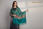 A Teal blue pashmina scarf with Kashmiri Aari embroidery in a floral pattern, featuring tassels on the ends.