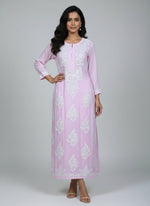 A baby pink colour Chikankari Kurti with white floral embroidery hanging on a hanger against a white background.