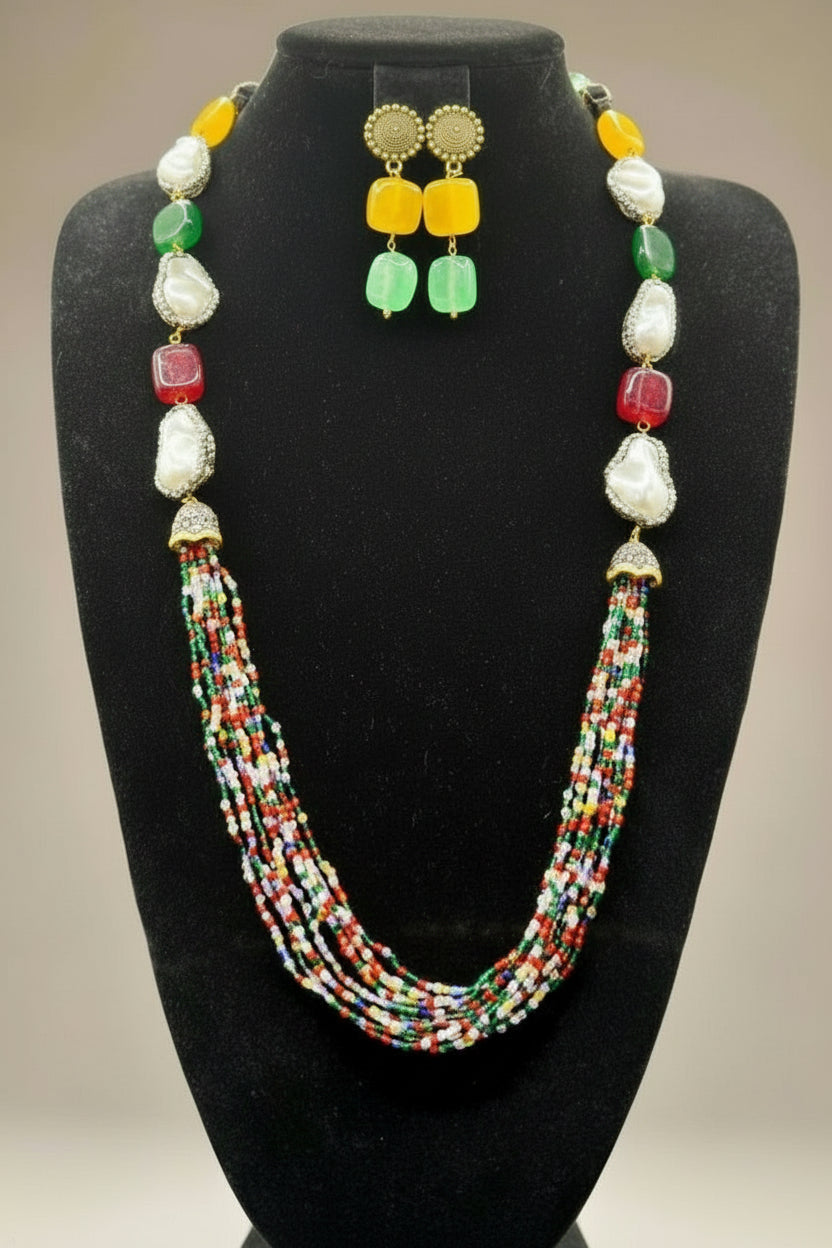 A black mannequin showcasing a Bollywood style Mona Lisa stone and crystal beaded Mala set, with multiple colours of beads and gold-tone accents. Party wear mala set.