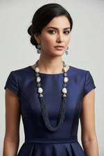 A black mannequin showcasing a Bollywood style Navy blue colour Mona Lisa stone and Navyblue colour nano crystal beaded Mala set, with white colours of baroque pearls and gold-tone accents.