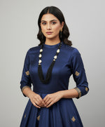 A black mannequin showcasing a Bollywood style black colour Mona Lisa stone and black colour nano crystal beaded Mala set, with white colours of baroque pearls and gold-tone accents.