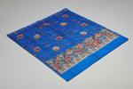 A blue Kashmiri embroidered pashmina scarf with floral patterns and a geometric border in orange and red.