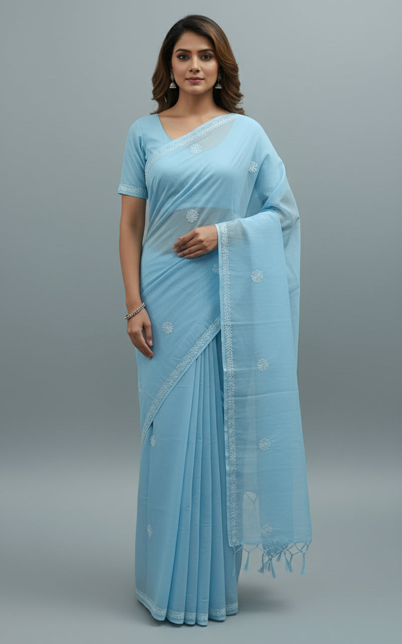 A blue cotton saree with floral embroidery and a blouse piece, draped over on a dummy by famaza couture