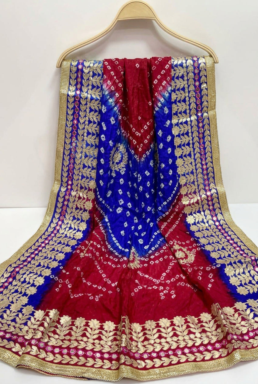 A dupatta/chunni/urrhni/scarf in fresh royal blue, hot pink colours with gota and bootis work displayed on a hanger.