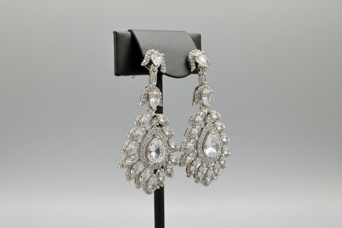 A earrings stand with leaf designs, featuring American diamonds whtie semi-precious stones. Party wear earrings.