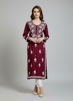 A fully embroidered maroon colour modal fabric kurti with floral Ghass Patti hand embroidery and a full border on display.
