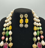 A gold-plated Kundan-studded and pearl-beaded handcrafted jewellery set, consisting of a necklace and earrings, displayed against a black background. Party wear set.