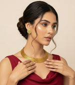 A gold-tone multi-layer Hasli necklace with golden stud earrings jewellery set by famaza couture