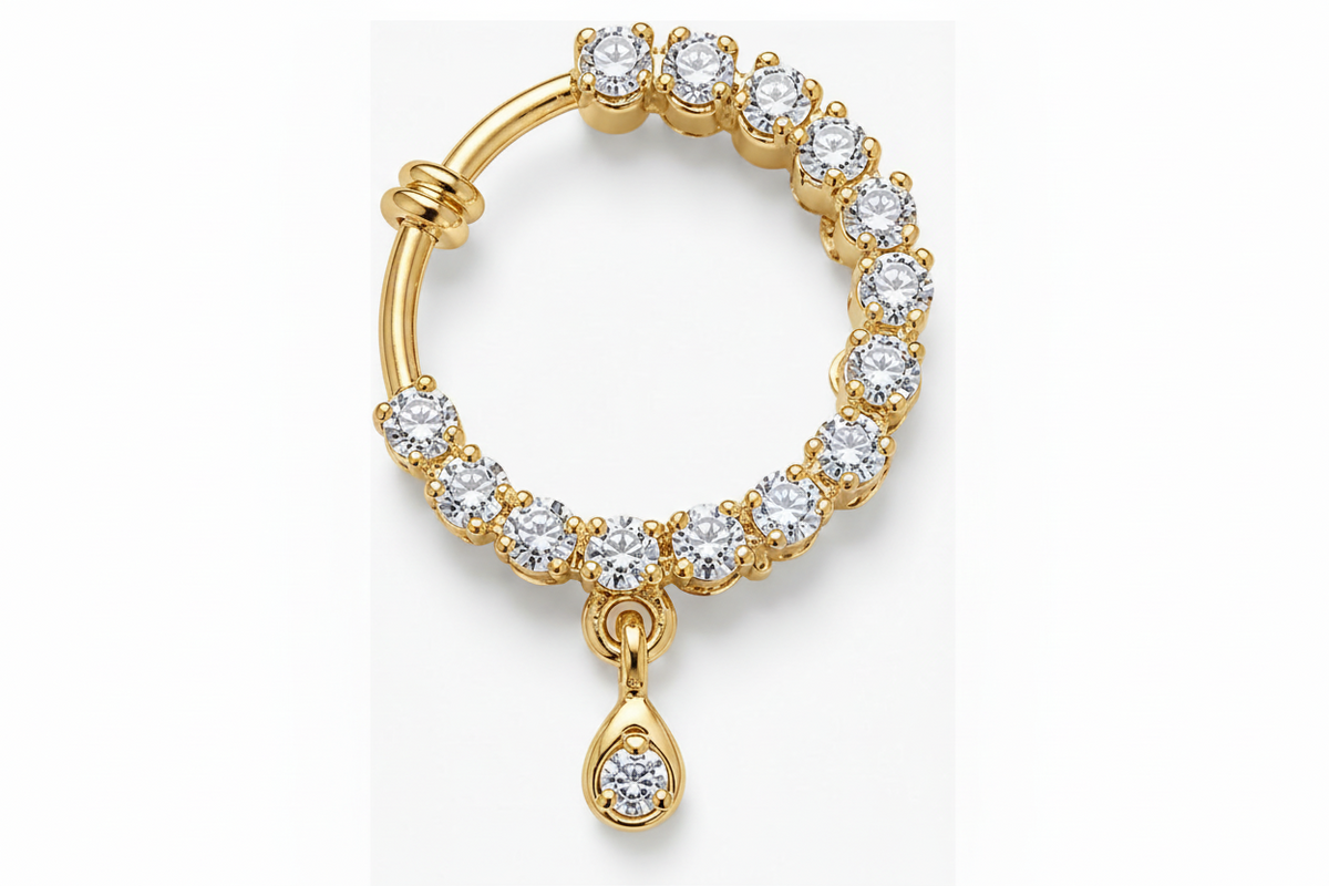A gold huggie hoop clip on nose ring adorned with round-cut clear stones and featuring a dangling teardrop-shaped clear stone, shown on a plain white background.