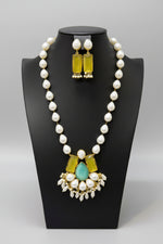 A luxury Bollywood style Mala Set featuring white beads, pearls, and yellow and turquoise stone inclusions, displayed on a mannequin bust. Party mala wear set.