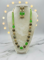 A luxury Tanjore Art Meenakari hot apple green beaded Mala Set, featuring a regal bridal necklace and matching earrings with green and gold details.
