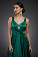 A mannequin showcasing a necklace and earrings set with leaf designs, featuring American diamonds and white semi-precious stones.