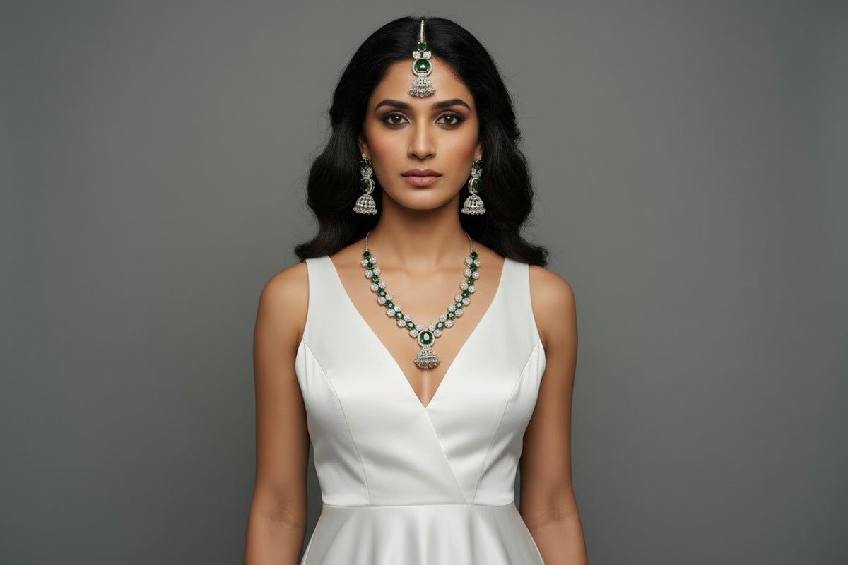 A mannequin showcasing a necklace set with bottle green and white stones, accompanied by earrings and a maang tikka. Party wear set.