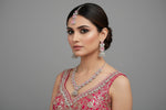 A mannequin showcasing a silver plated necklace set with pink and white stones, accompanied by earrings and a maang tikka. Party wear ad set.