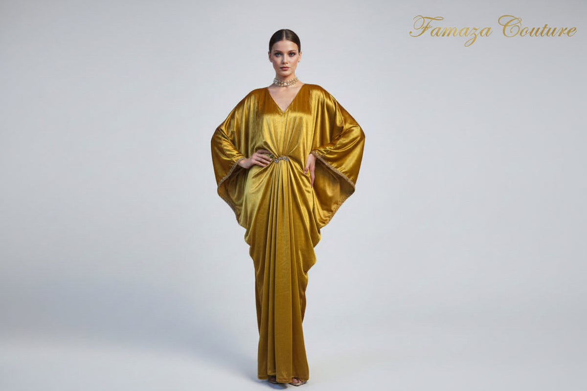 A mustard colourvelvet long kaftan dress displayed on a mannequin, featuring batwing sleeves design withV-neckline.