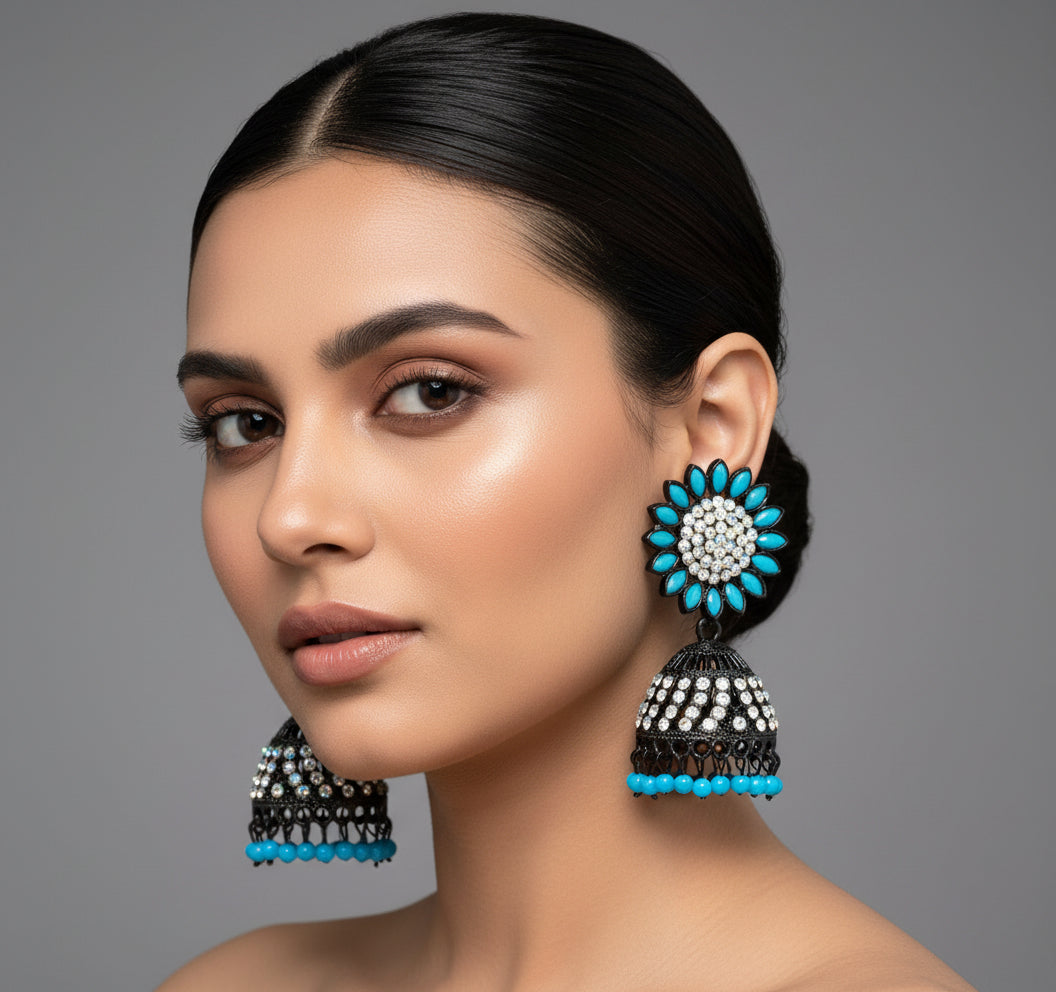 A pair of black Jhumki earrings with sunflower designs, featuring sky blue and silver multi shade stones and sky blue nano hangings.