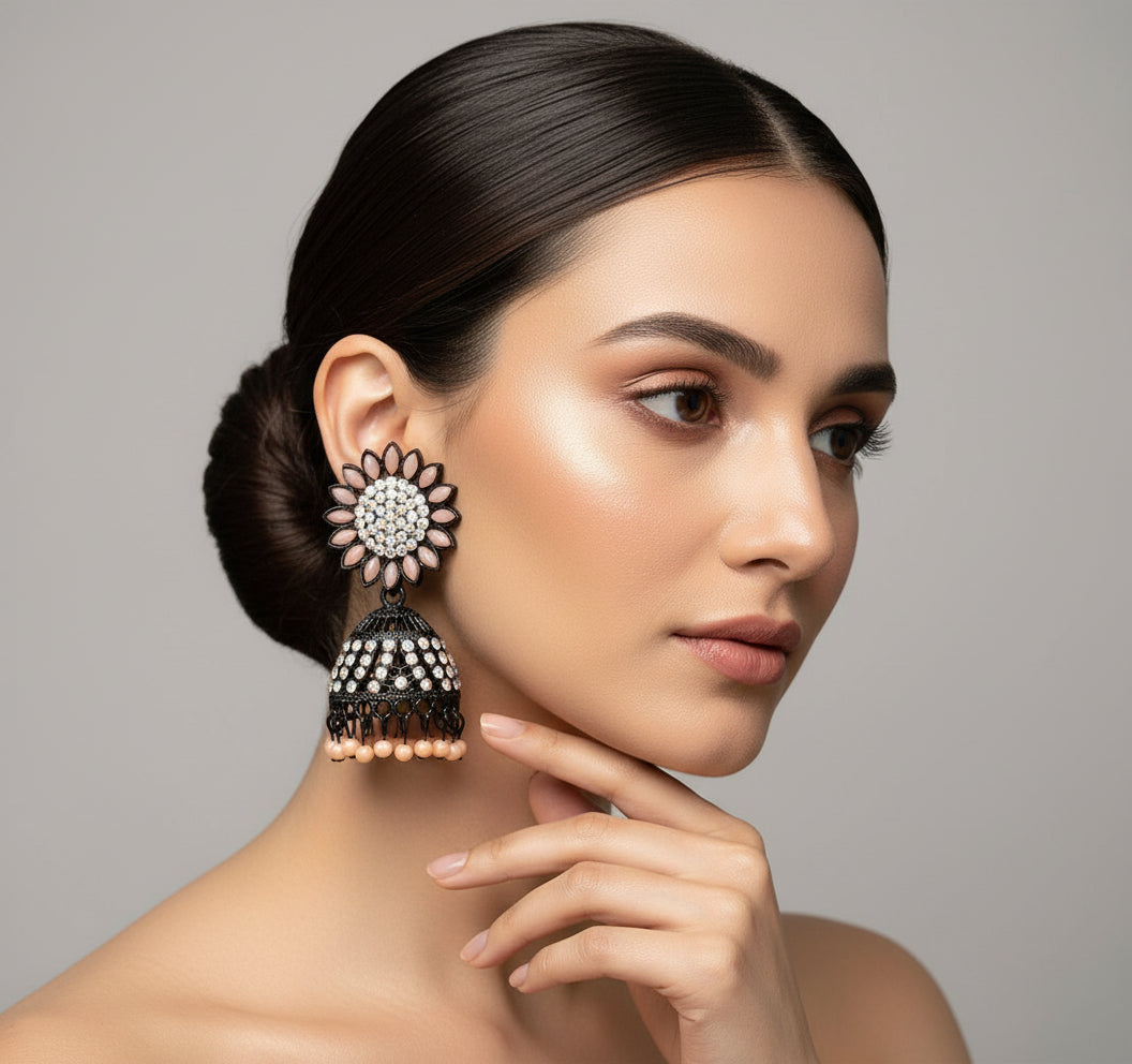 A pair of black base metal Jhumki earrings with sunflower designs, featuring peach and silver multi shade stones and sky blue nano hangings.