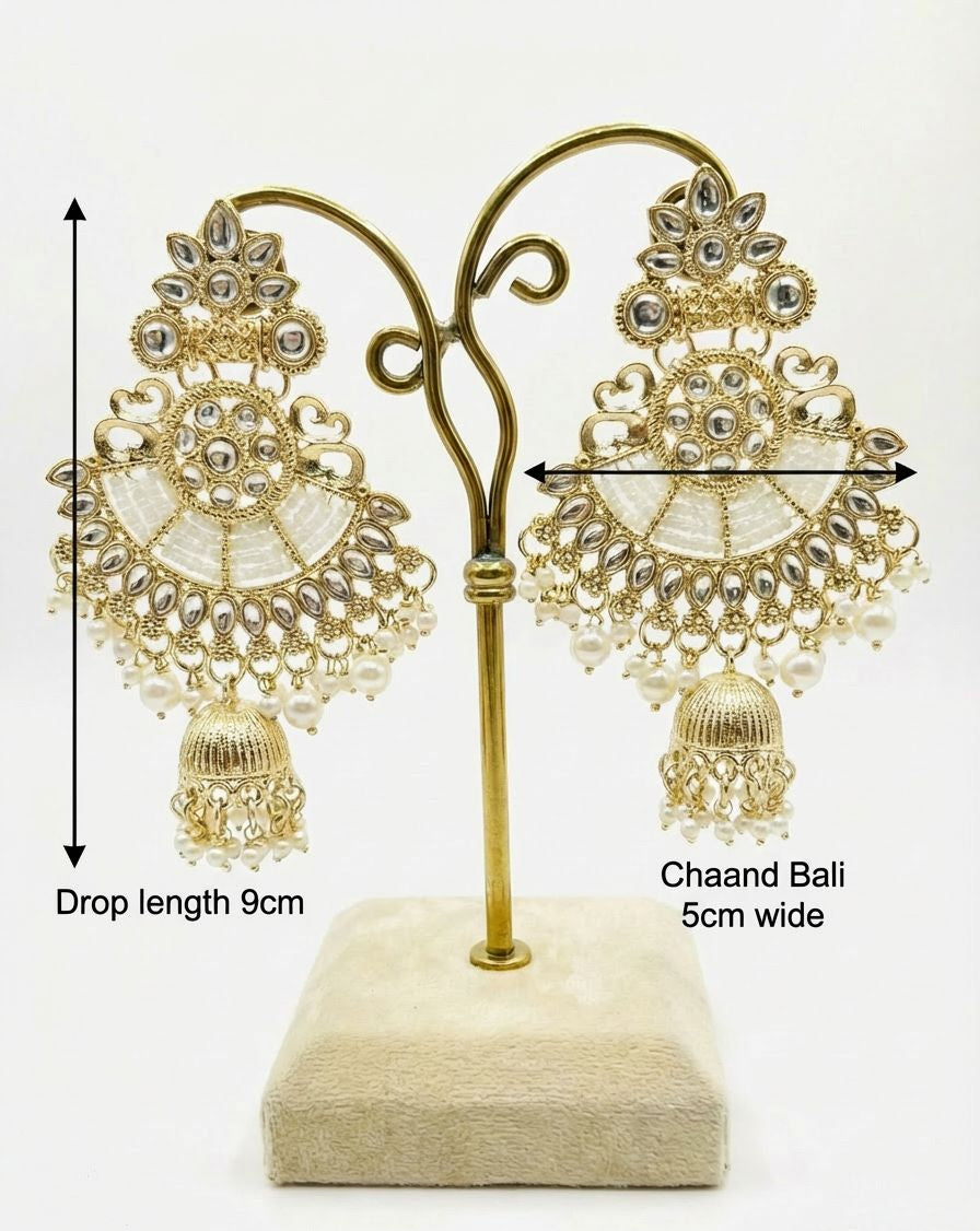 A pair of dull gold Chaand Bali earrings featuring nano white beaded sections and small pearl droplets hanging from the base.
