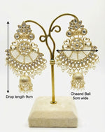 A pair of dull gold Chaand Bali earrings featuring nano white beaded sections and small pearl droplets hanging from the base.