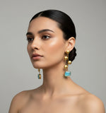 A pair of gold-plated Monalisa sky blue stone earrings with golden coin details.