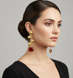 A pair of gold-plated earrings with red Monalisa stone and coin details.
