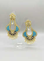 A pair of gold-toned chandbali earrings with blue and black minakari and kundan studded details along with pearls. Party wear.