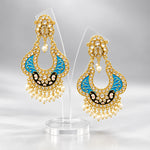 A pair of gold-toned chandbali earrings with blue and black minakari and kundan studded details along with pearls. Party wear.