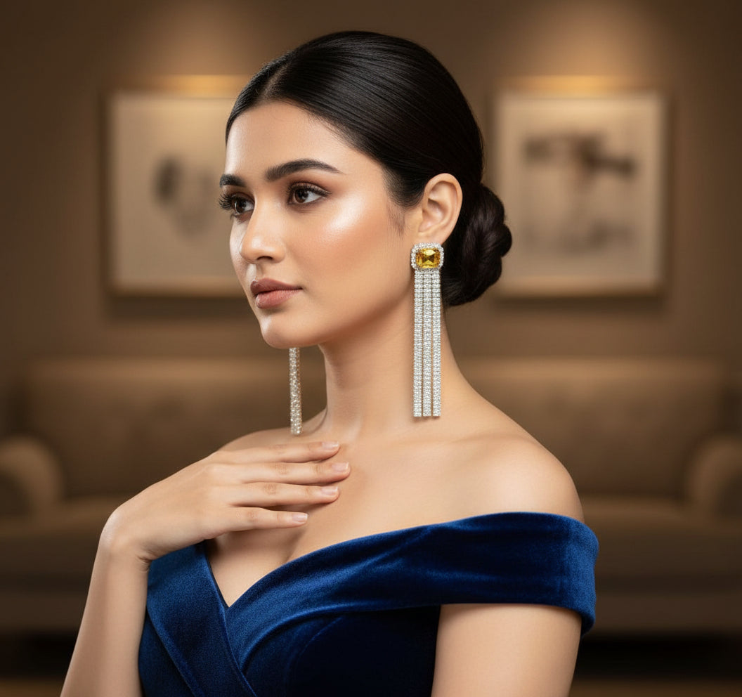 A pair of silver finish cubic zirconia drop earrings with yellow doublet semi precious stones. Party wear earrings.