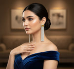 A pair of silver finish cubic zirconia drop earrings with yellow doublet semi precious stones. Party wear earrings.