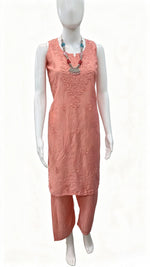 A peach-coloured two-piece kurta set with matching pants displayed on a white mannequin, featuring a sleeveless tunic with floral embroidery and a coordinating pair of straight pants.