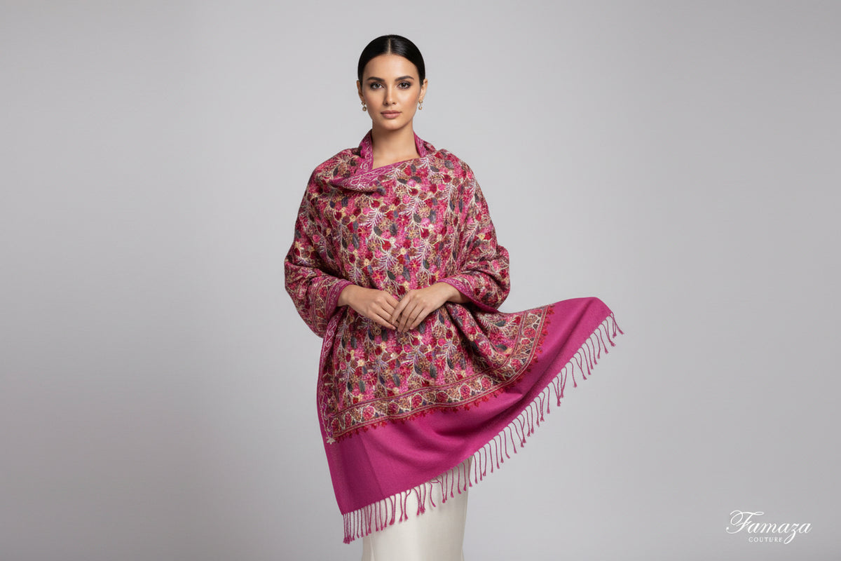 A pink Kashmiri embroidered pashmina scarf with a traditional geometric pattern, featuring fringes at the ends.