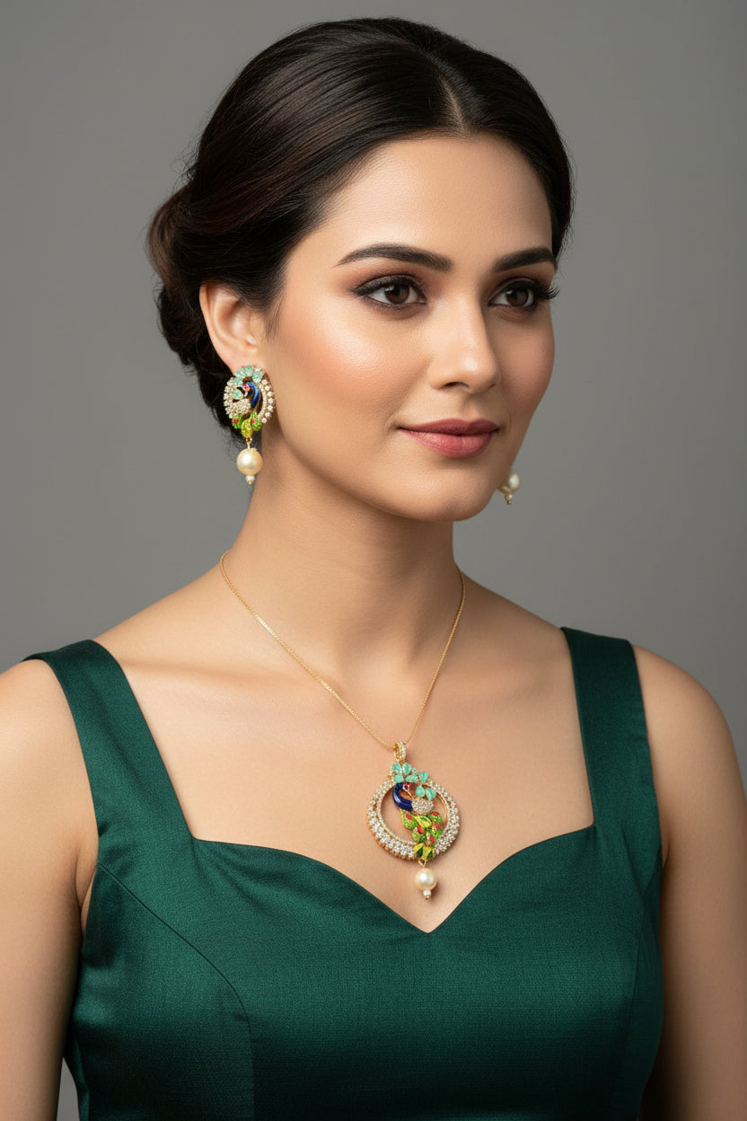 A rhodium-gold plated brass pendant with a peacock design accompanied by earrings, featuring vibrant green, blue, and gold enamel accents, as well as white and turquoise AD stones sparkling embellishments. Party wear jewellery set.